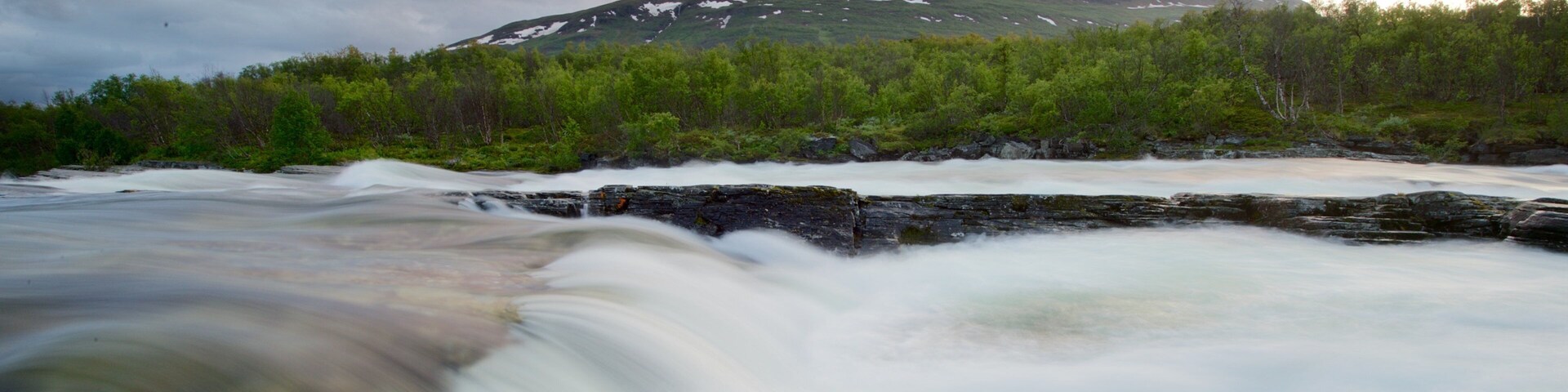 Abisko National Park which includes a sunset and a river or creek