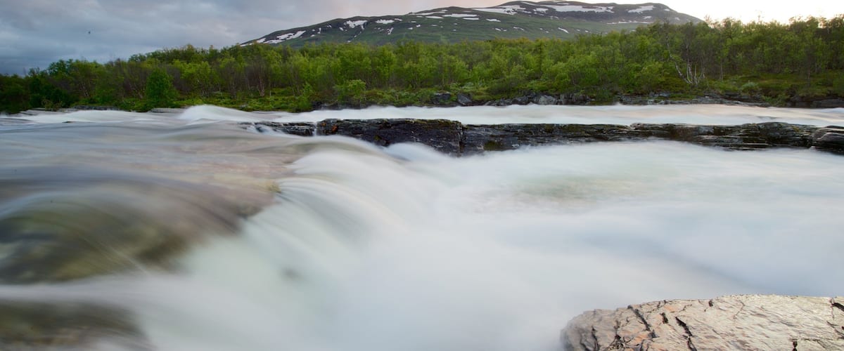 Abisko National Park showing a river or creek and a sunset