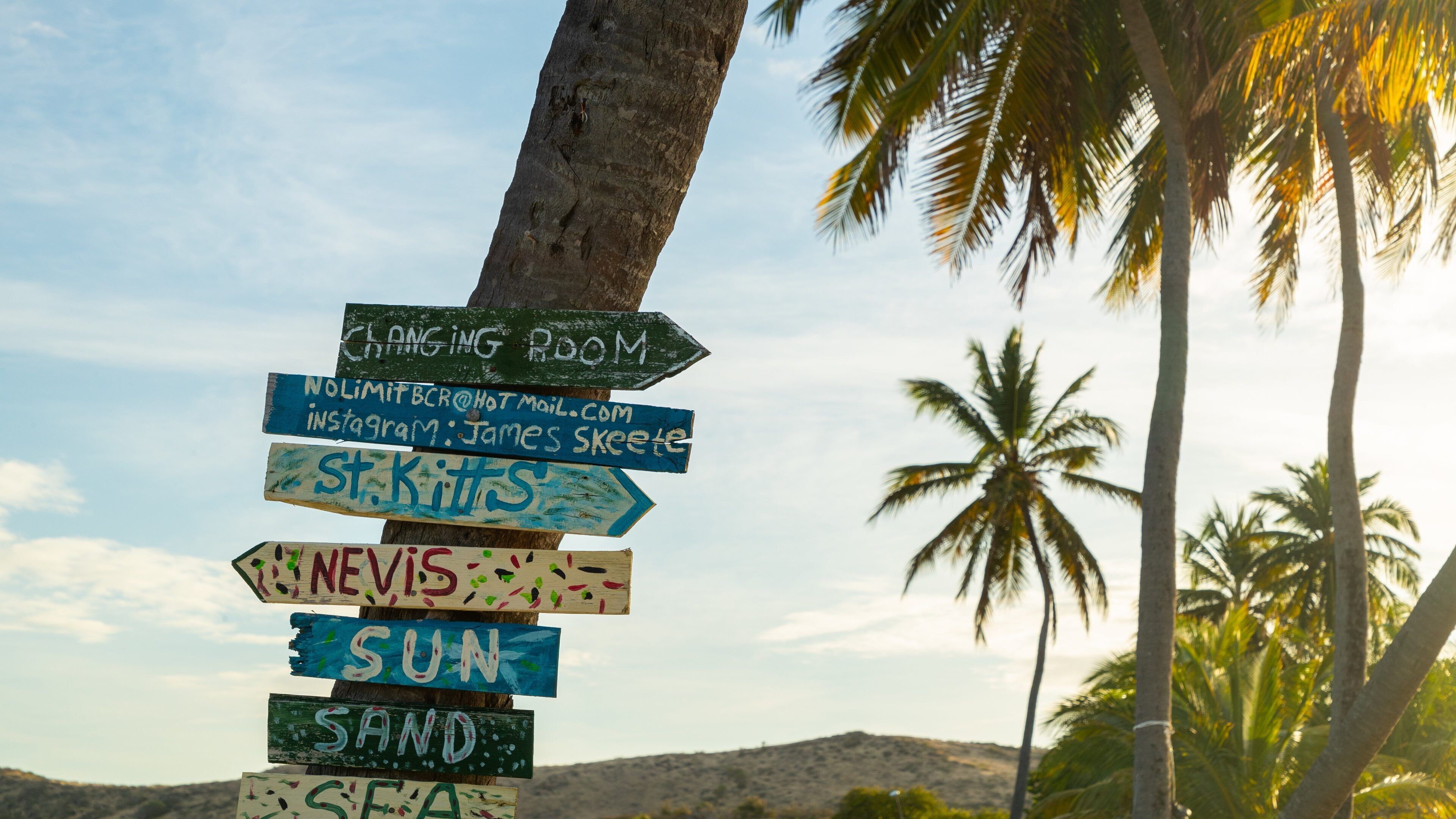 Cockleshell Bay which includes signage, a sunset and tropical scenes