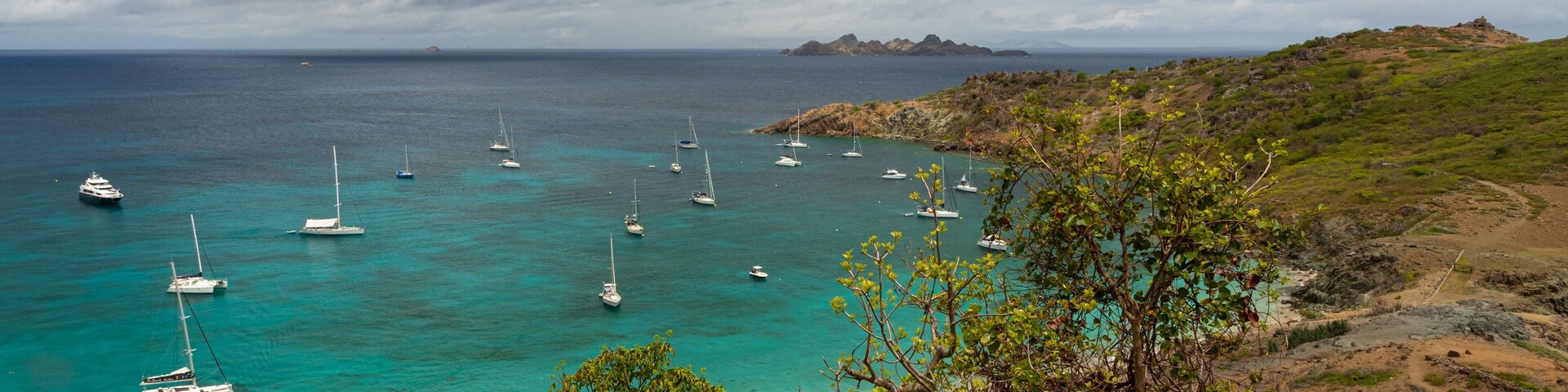 Colombier Beach which includes a bay or harbor, general coastal views and landscape views