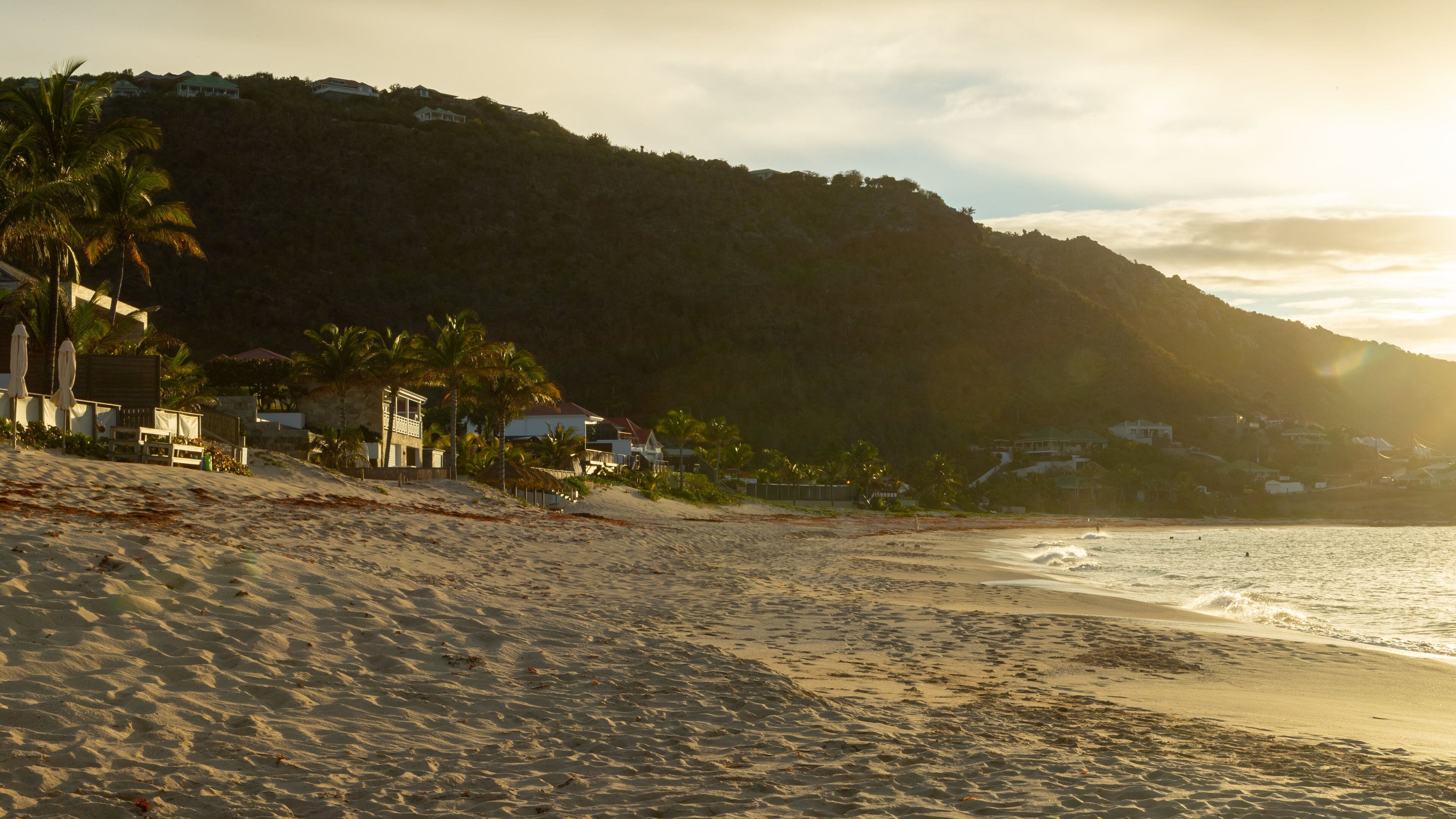 Flamands Beach which includes a sunset, a beach and a coastal town