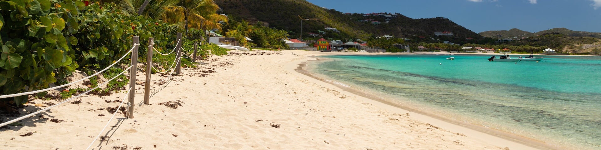 Lorient Beach which includes tropical scenes, general coastal views and a sandy beach