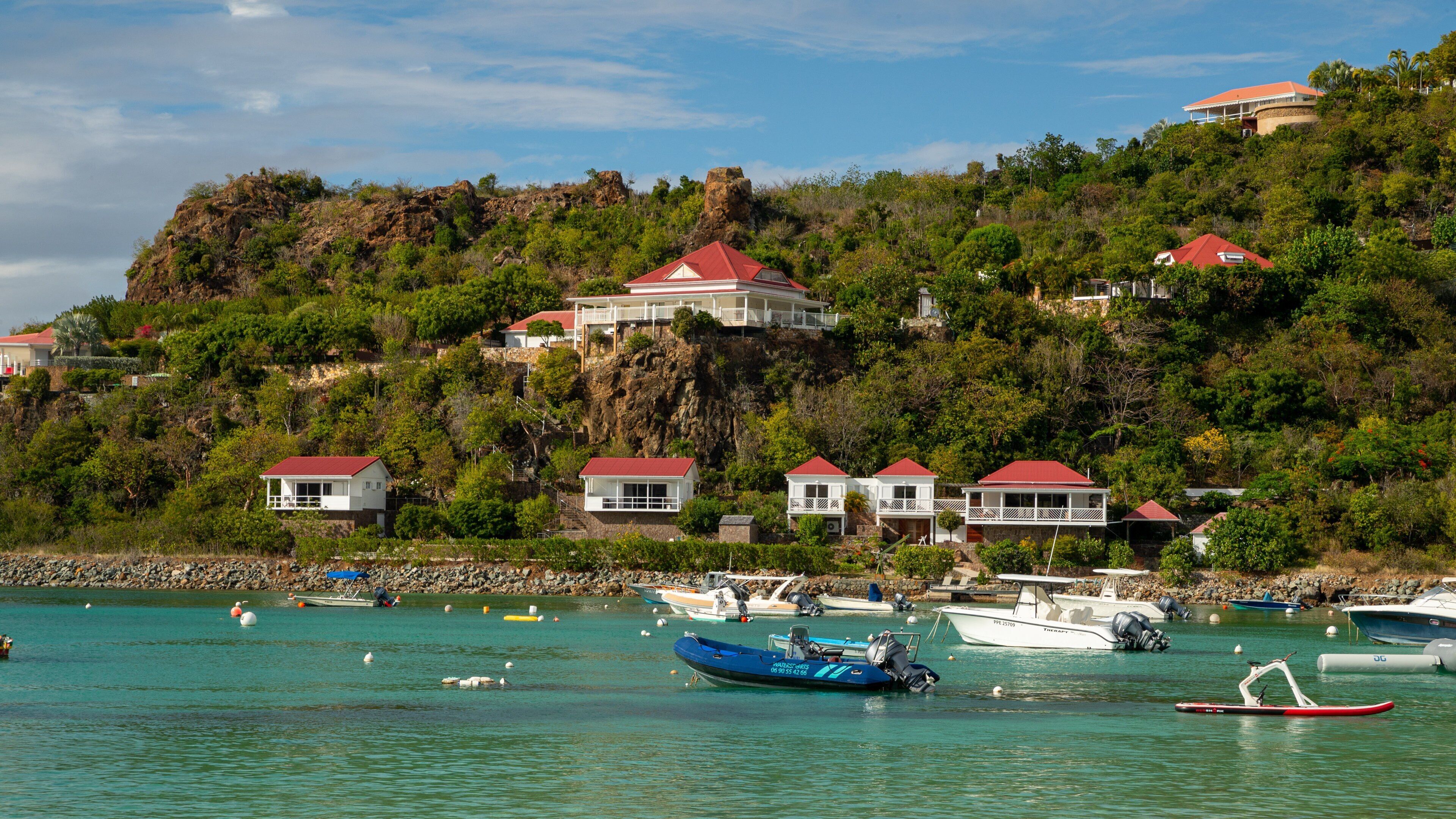 St. Jean Beach which includes a bay or harbor, a coastal town and general coastal views