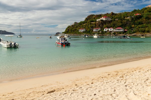 St. Jean Beach which includes a bay or harbor, general coastal views and a sandy beach