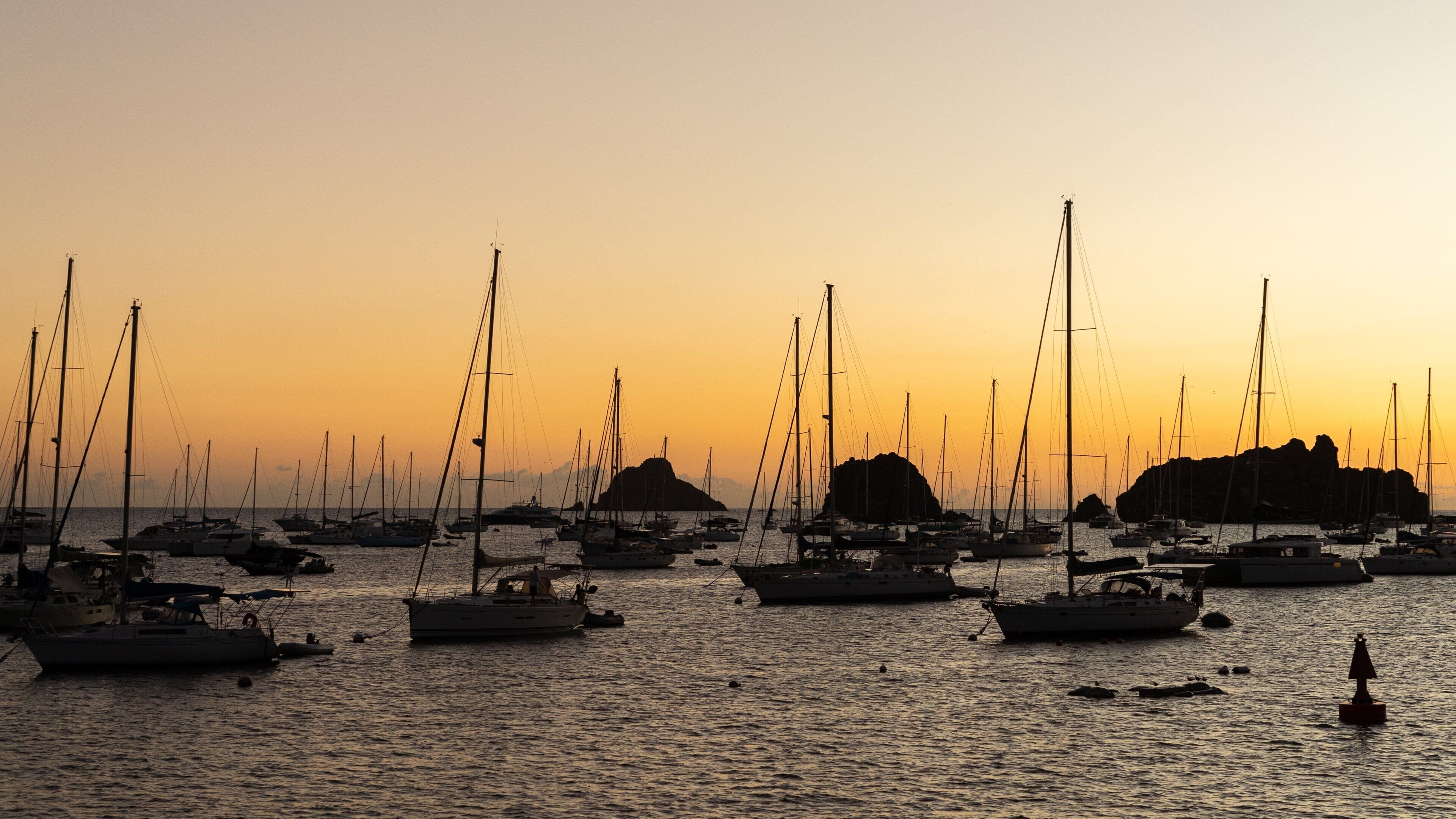 Gustavia Harbor which includes a sunset, general coastal views and a bay or harbor