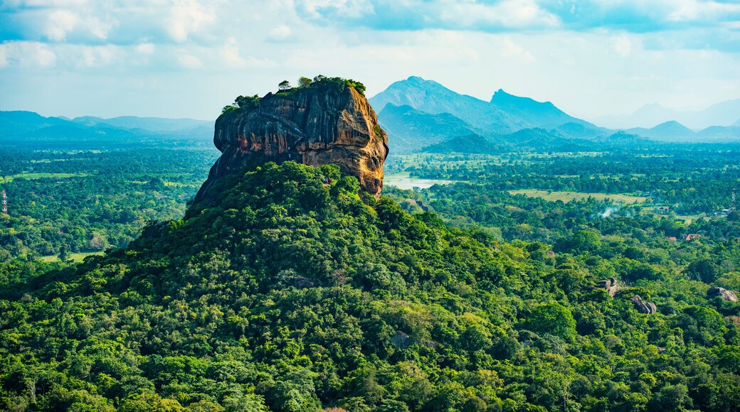 Spectacular view of the Lion rock surrounded by green rich vegetation. Picture taken from Pidurangala Rock in Sigiriya, Sri Lanka.
