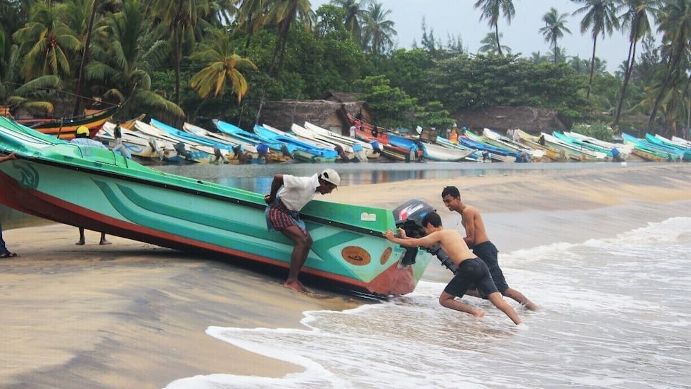 My travelling mate Minul Tennakoon pushes a fishing boat away from the sea with fisherman.
Arugambay is the best place for sea surfing. It is also known as the Surfers paradise of Sri Lanka. So, many tourists who love sea bathing and surfing visit this place.
