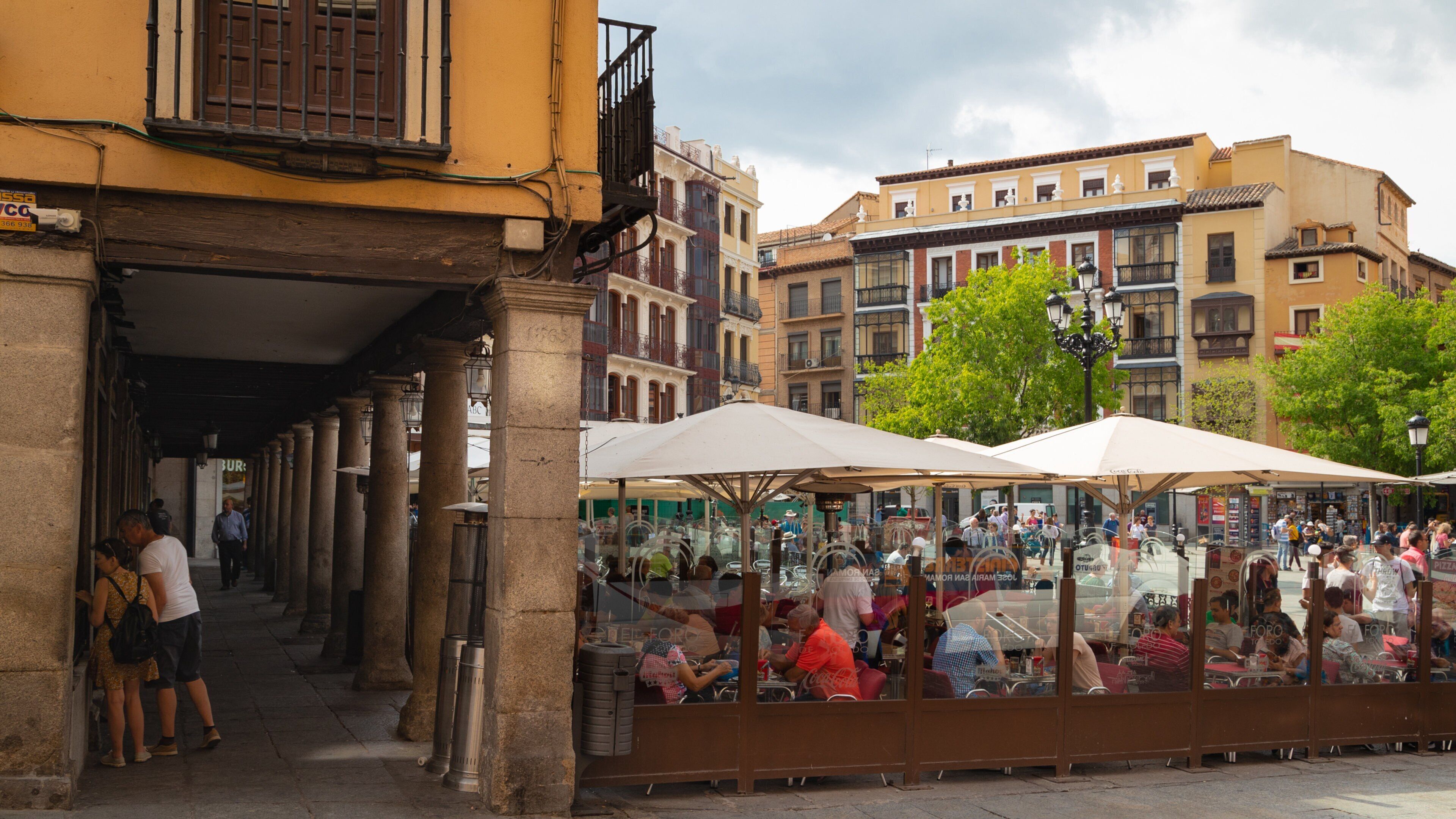 Plaza de Zocodover which includes outdoor eating as well as a small group of people