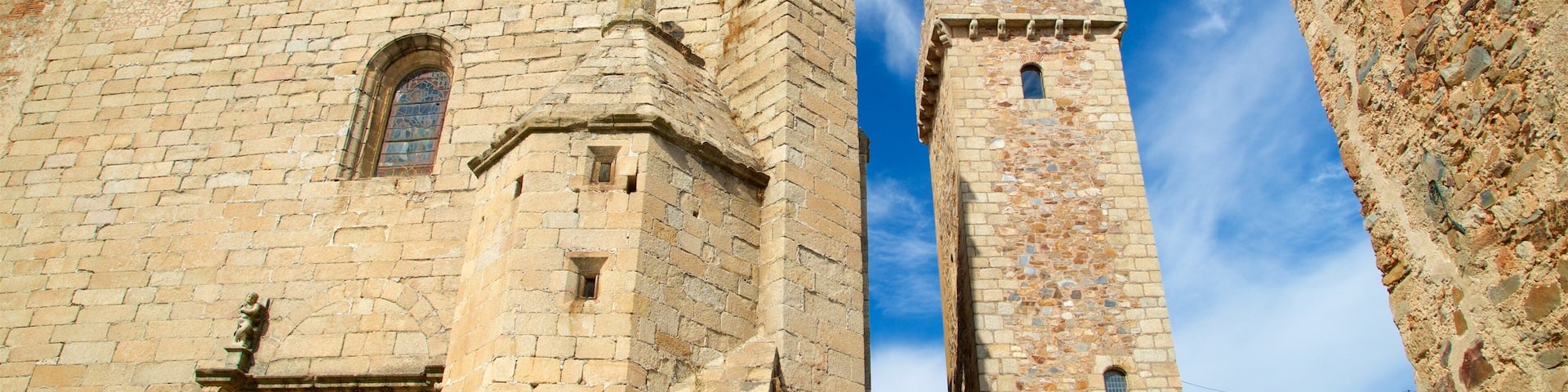 A historic stone building with a bell tower and a clock.