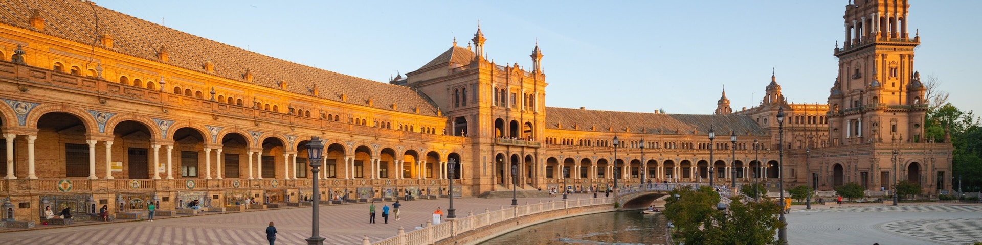 Plaza de Espana featuring a sunset, heritage architecture and a river or creek