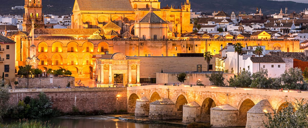 Cordoba, Spain at the Roman Bridge and Mosque-Cathedral on the Guadalquivir River.
