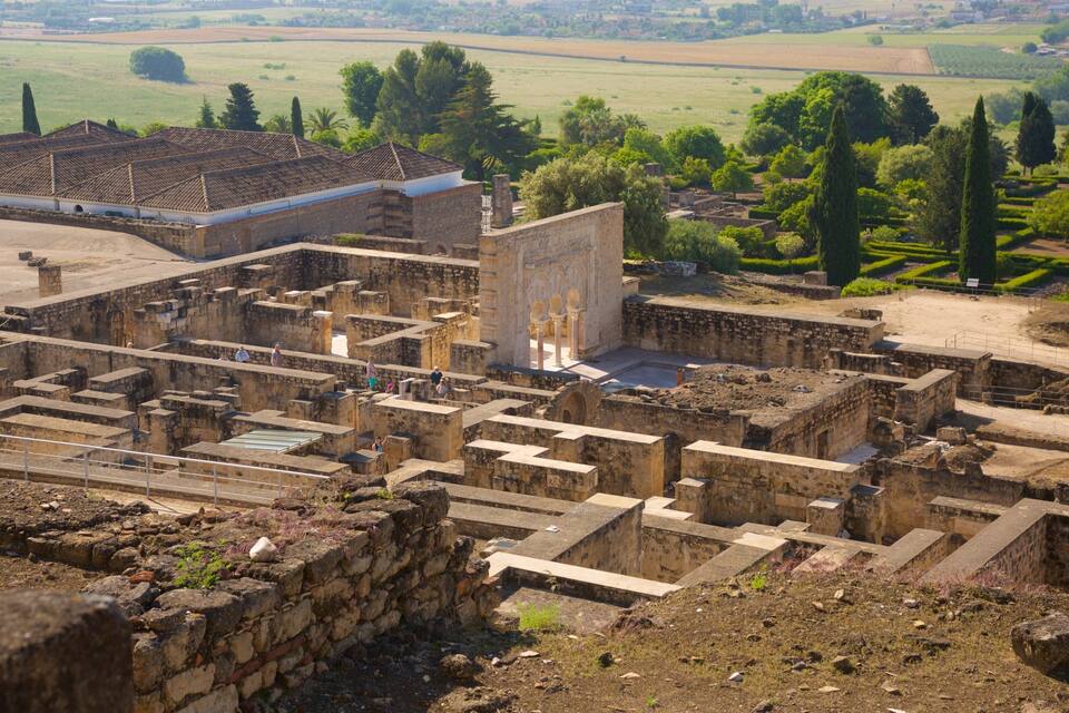 An ancient archaeological site with ruins and a large building with columns.