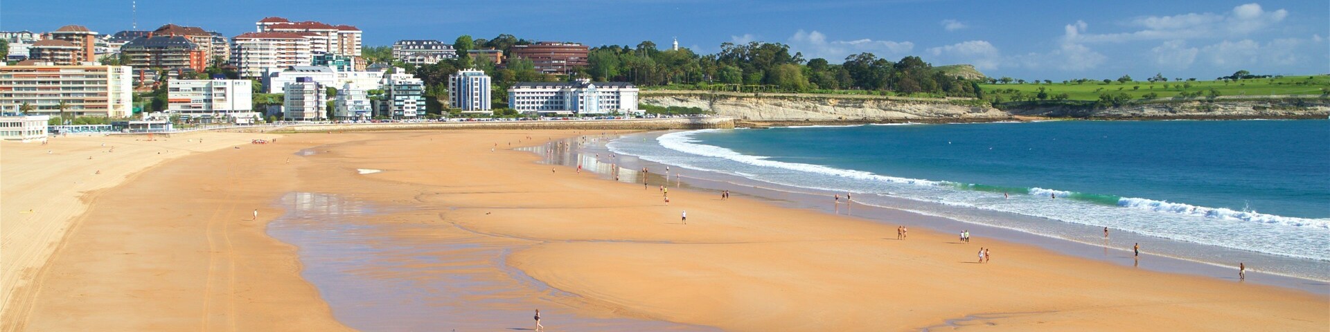 Camello Beach featuring a coastal town, a sandy beach and a city