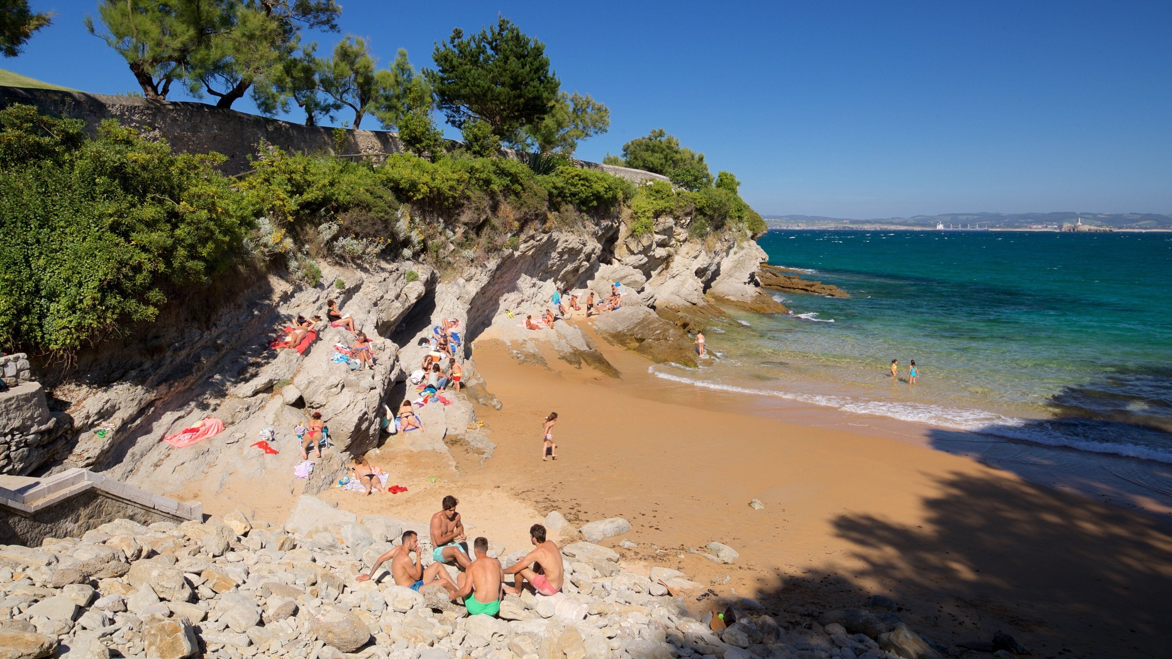 El Sardinero Beach featuring rocky coastline, a beach and general coastal views