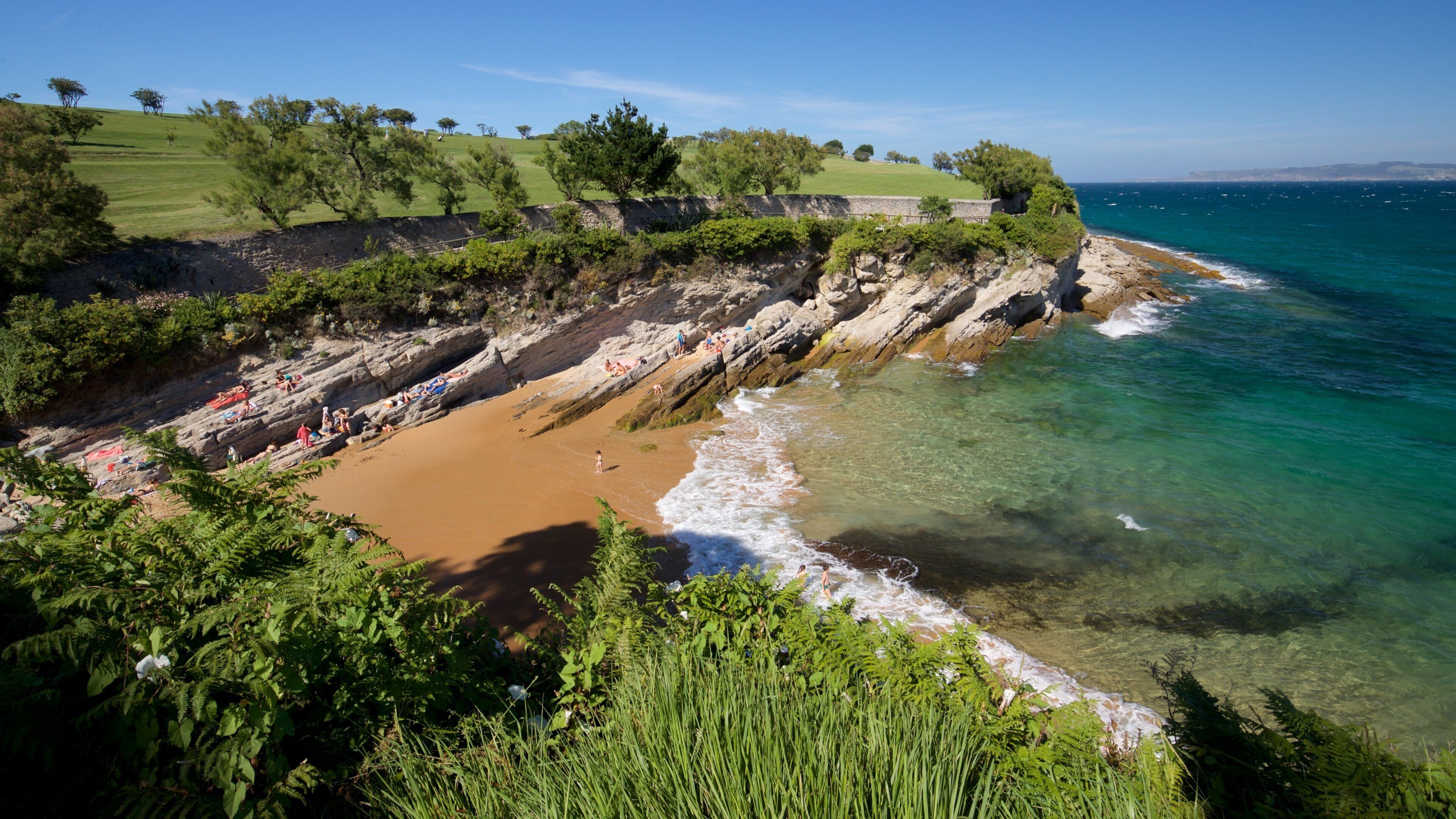 El Sardinero Beach showing a sandy beach, rugged coastline and general coastal views