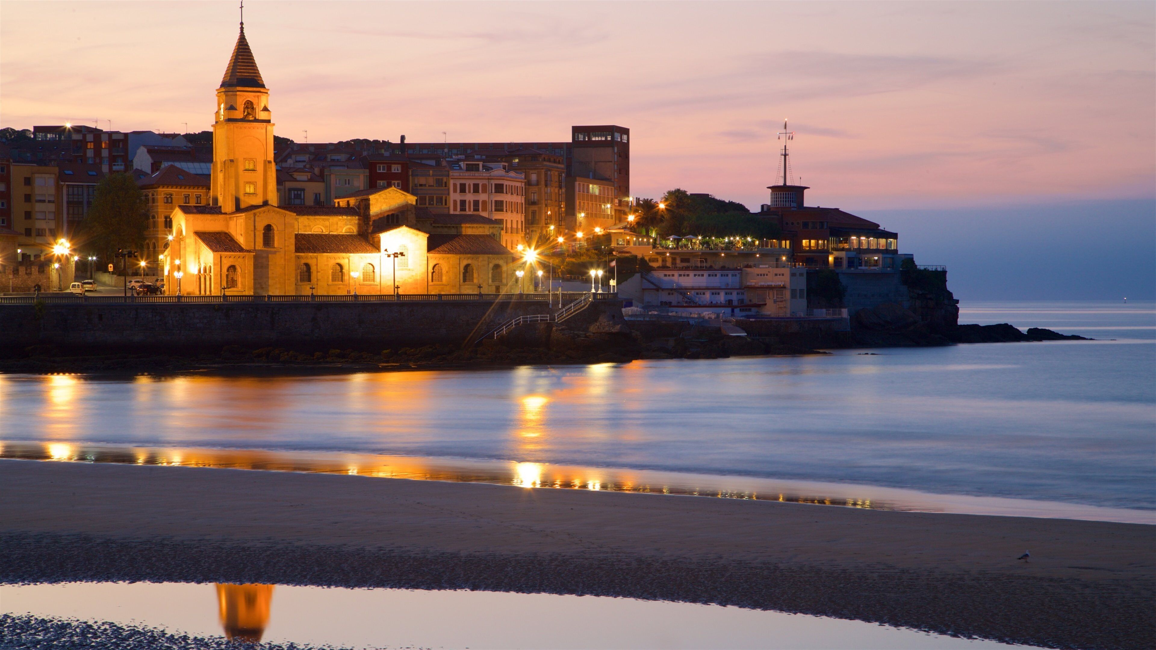 San Lorenzo Beach which includes a church or cathedral, a sandy beach and general coastal views