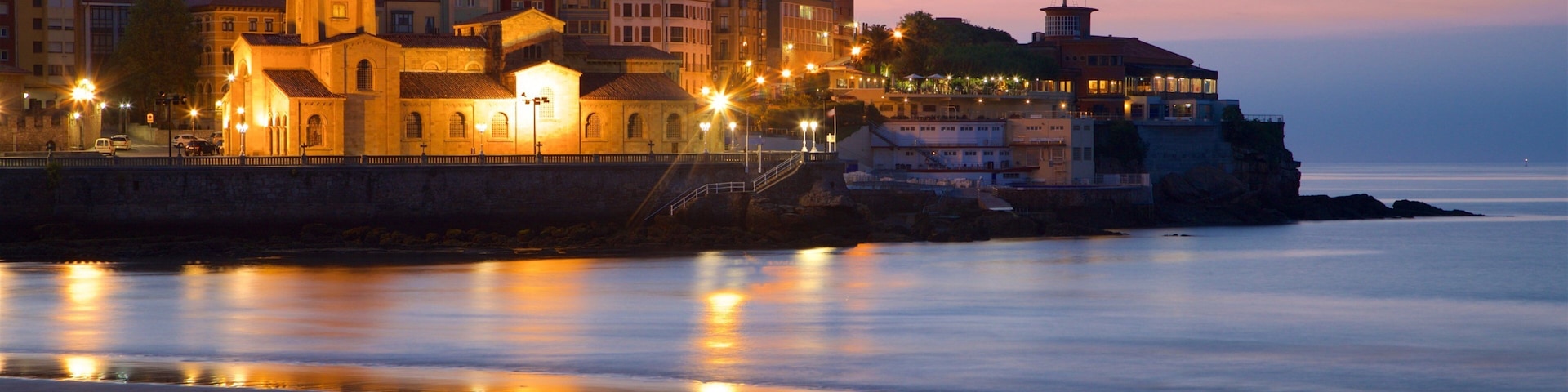 San Lorenzo Beach which includes a church or cathedral, a sandy beach and general coastal views