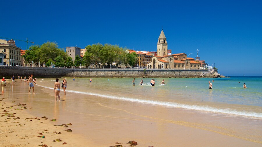 San Lorenzo Beach which includes swimming, a coastal town and a sandy beach