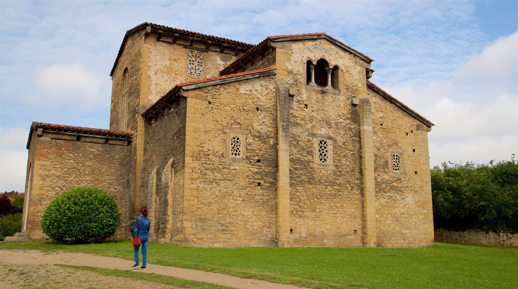 San Julian de los Prados showing heritage architecture as well as an individual femail