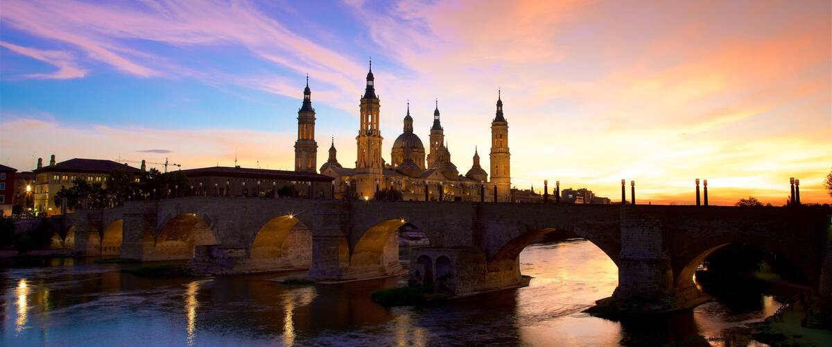 Basilica de Nuestra Senora del Pilar which includes a river or creek, heritage architecture and a bridge