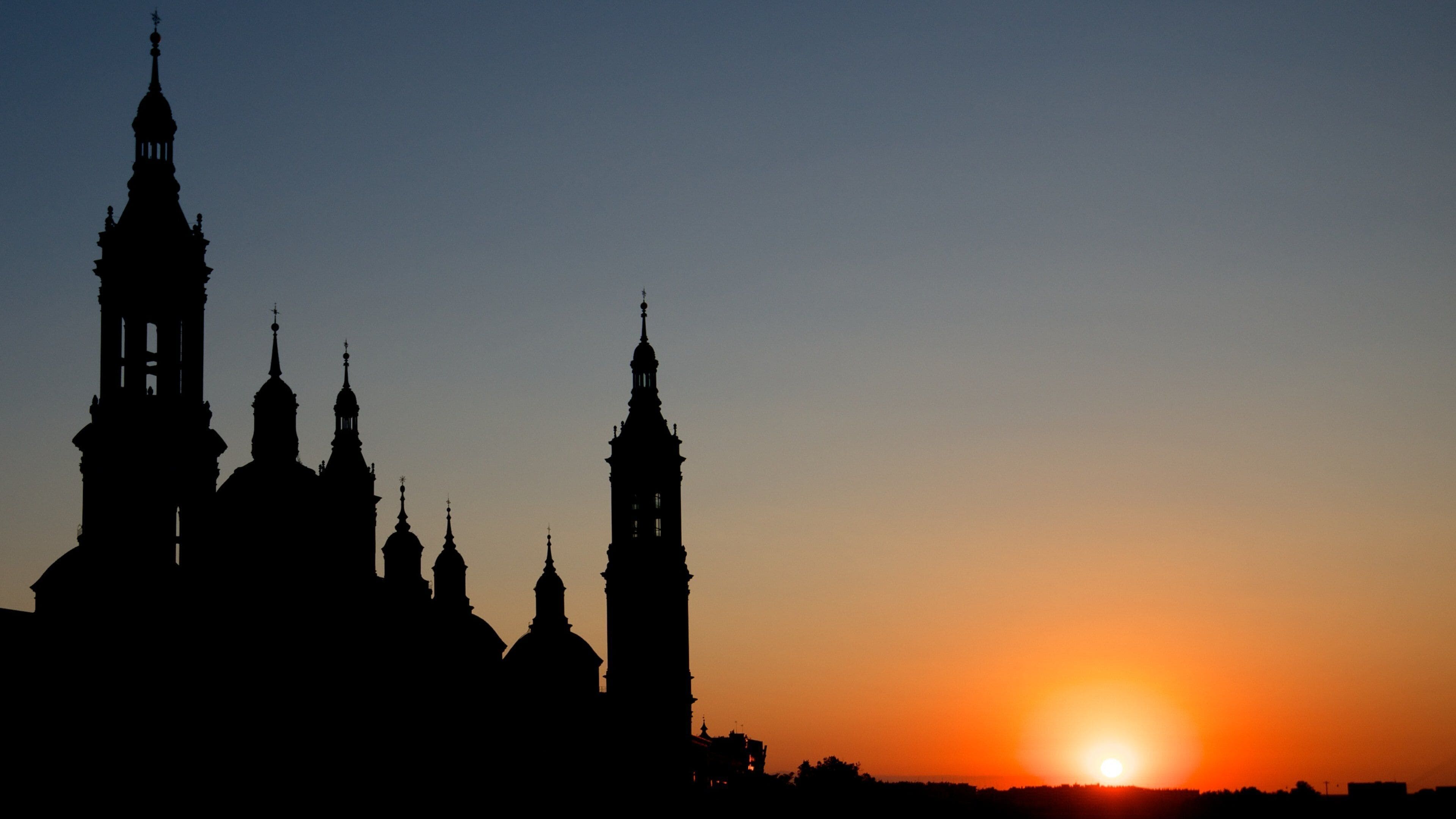 Basilica de Nuestra Senora del Pilar showing night scenes, a sunset and religious elements