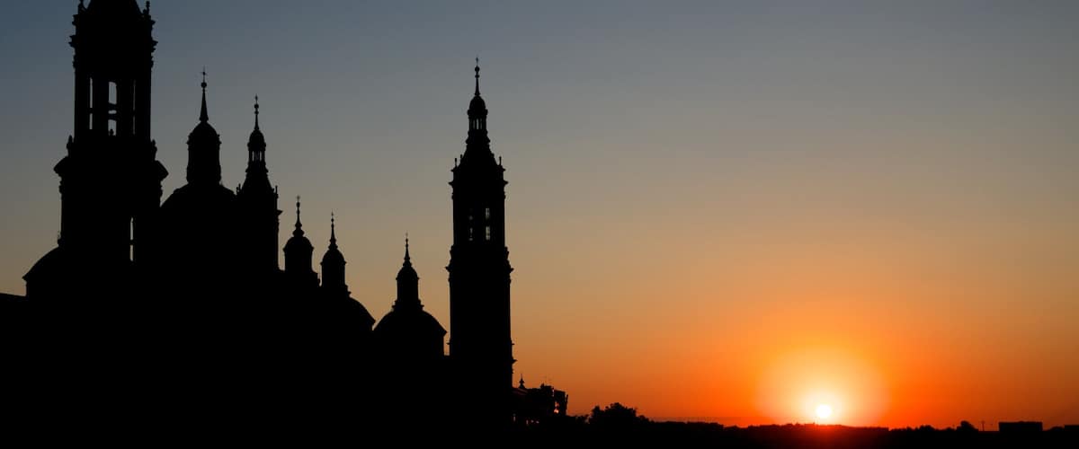 Basilica de Nuestra Senora del Pilar showing night scenes, a sunset and religious elements