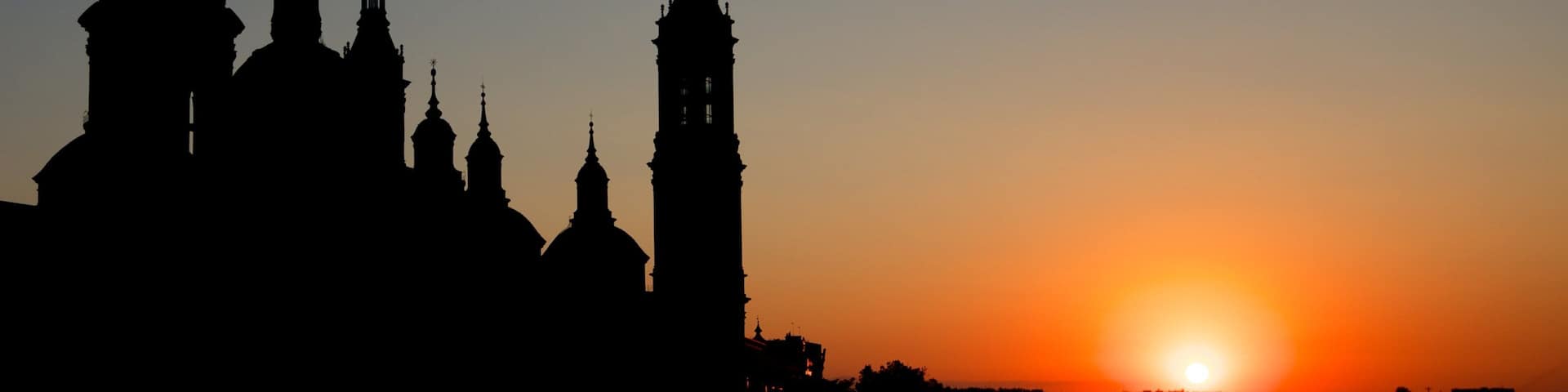 Basilica de Nuestra Senora del Pilar showing night scenes, a sunset and religious elements