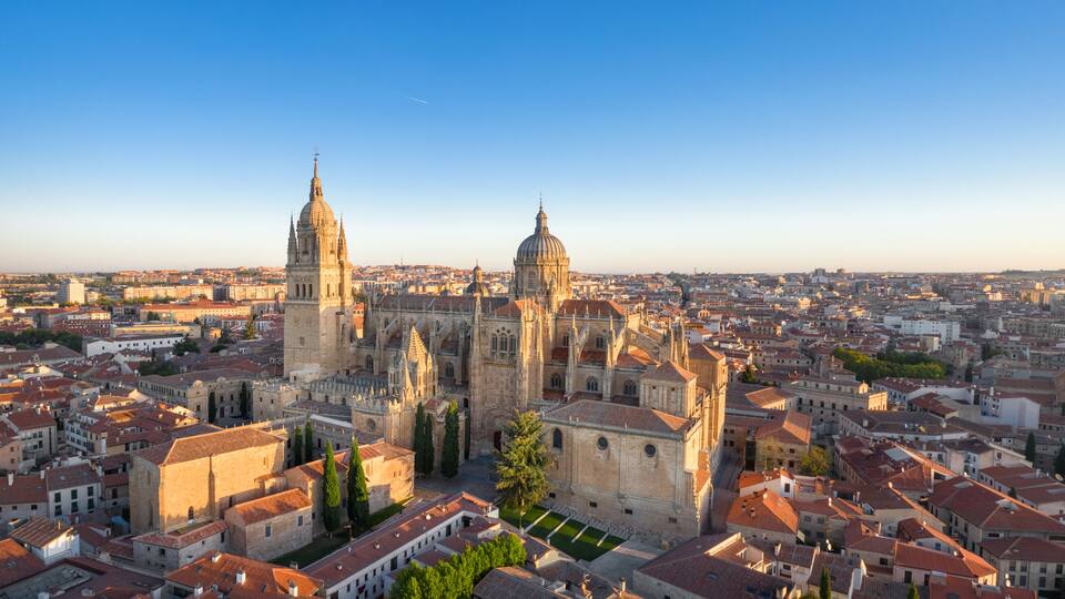 Panoramic aerial cityscape of Salamanca, Spain with building of New Cathedral on sunrise