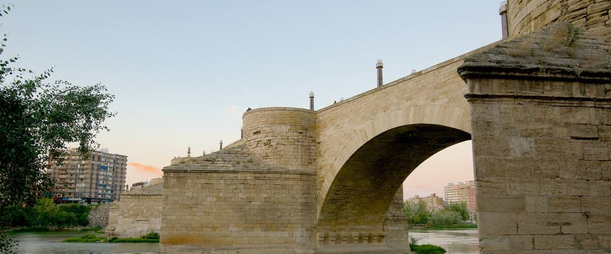 Puente de Piedra showing a river or creek, heritage architecture and a bridge