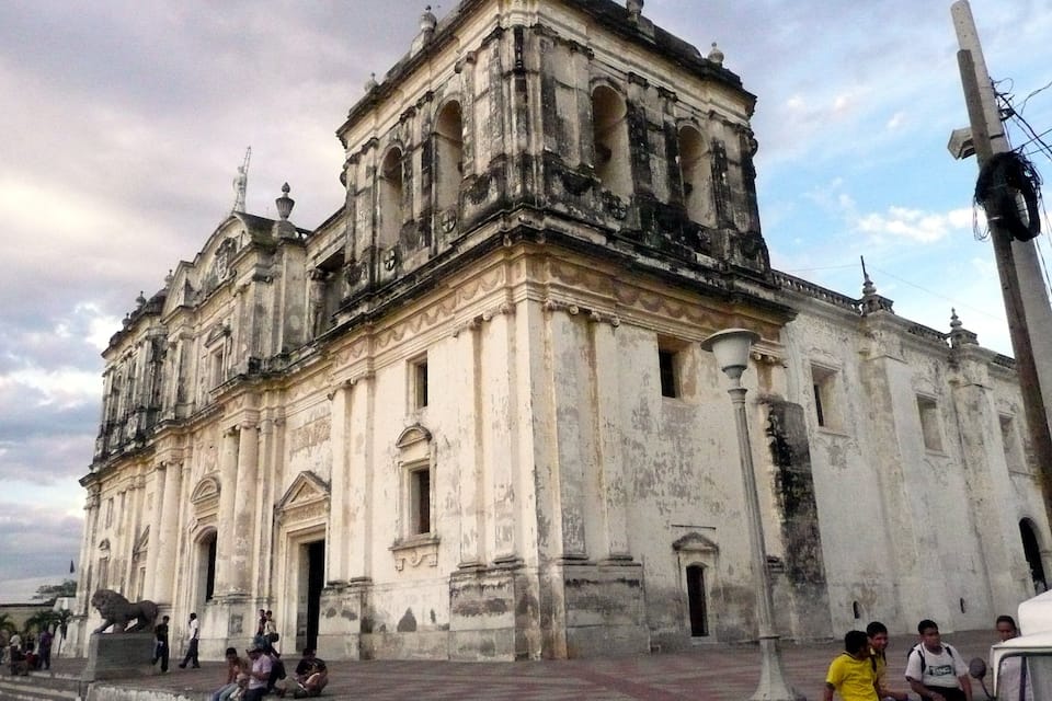 A historic cathedral with intricate architecture and a lion statue.