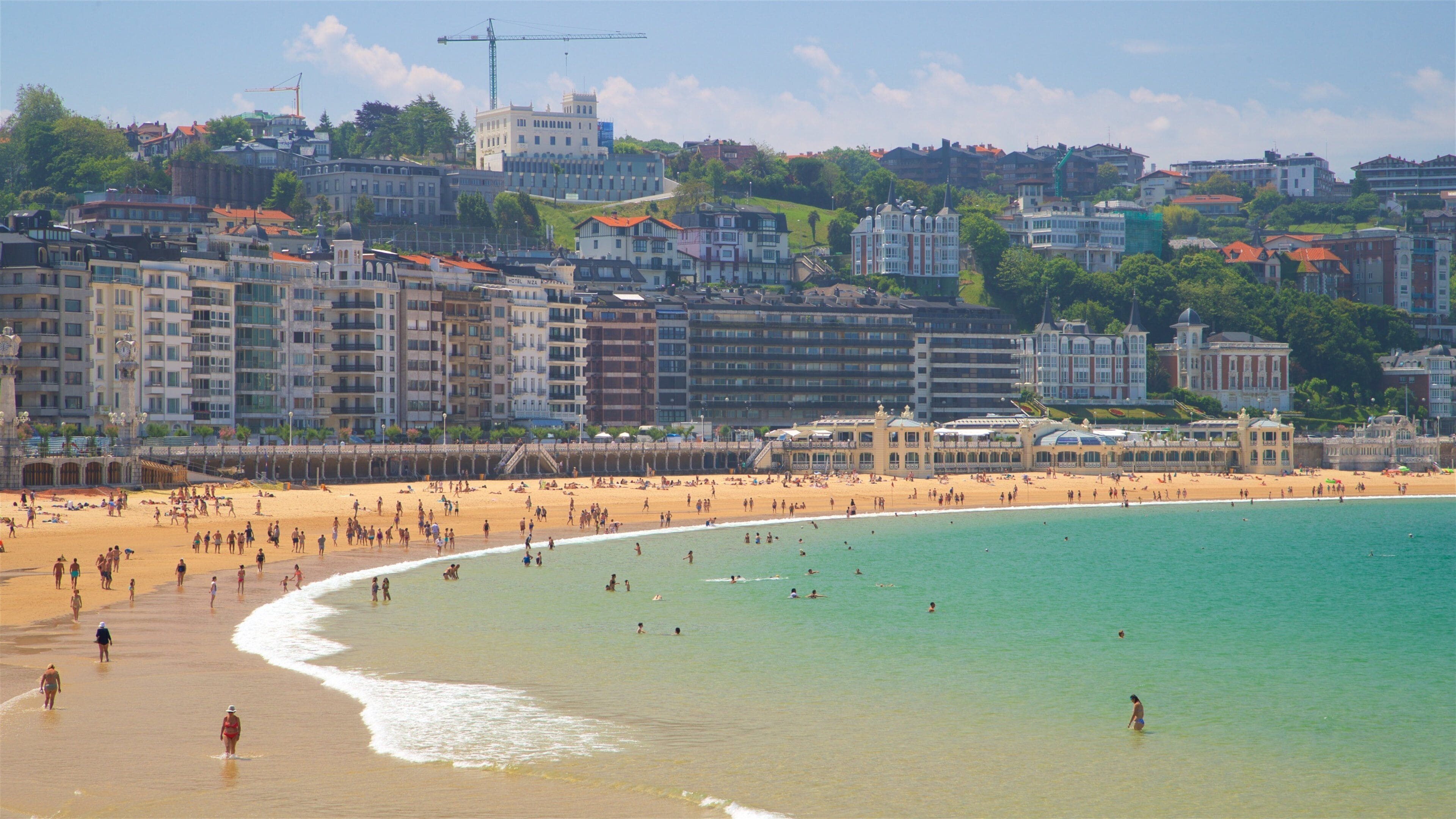 Concha Beach which includes swimming, a beach and a coastal town