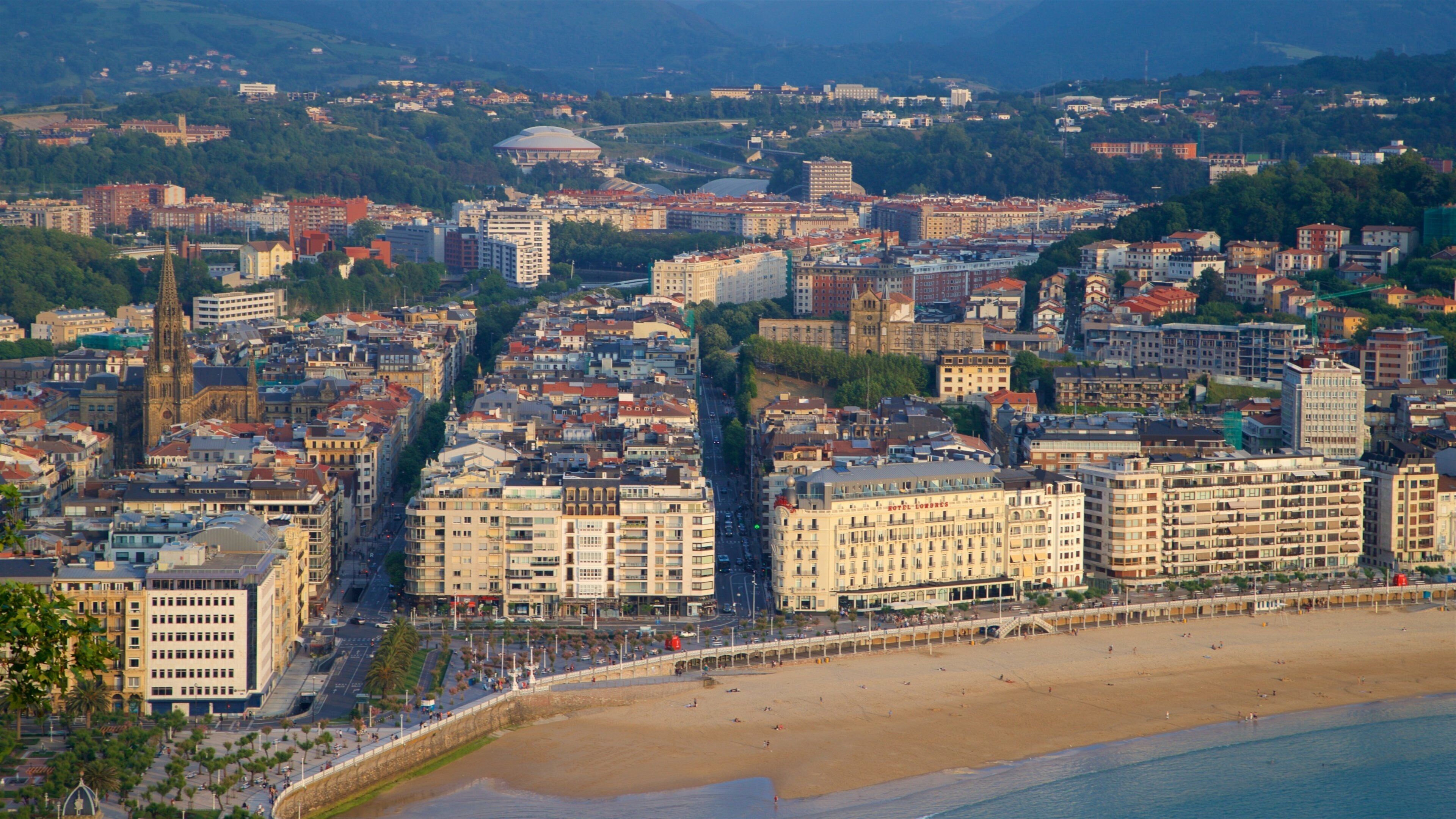Monte Urgull which includes a beach, a coastal town and general coastal views