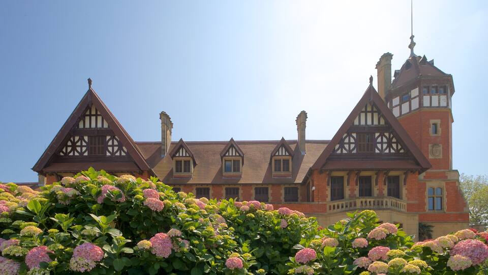 A large, historic building with Tudor-style architecture, including steeply pitched gable roofs and decorative half-timbering.