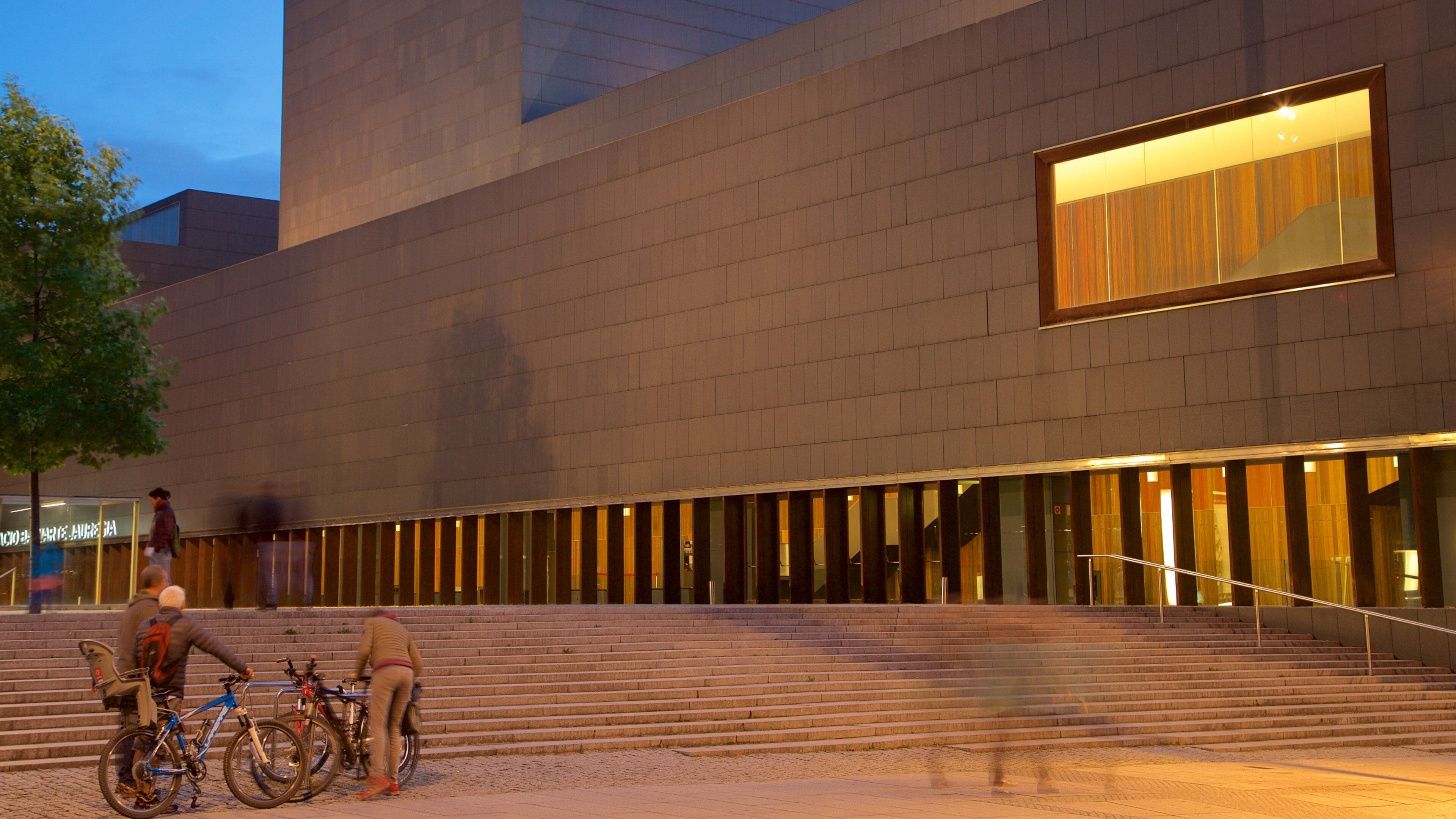 Palacio de Congresos and Auditorium of Navarra showing night scenes and street scenes as well as a small group of people