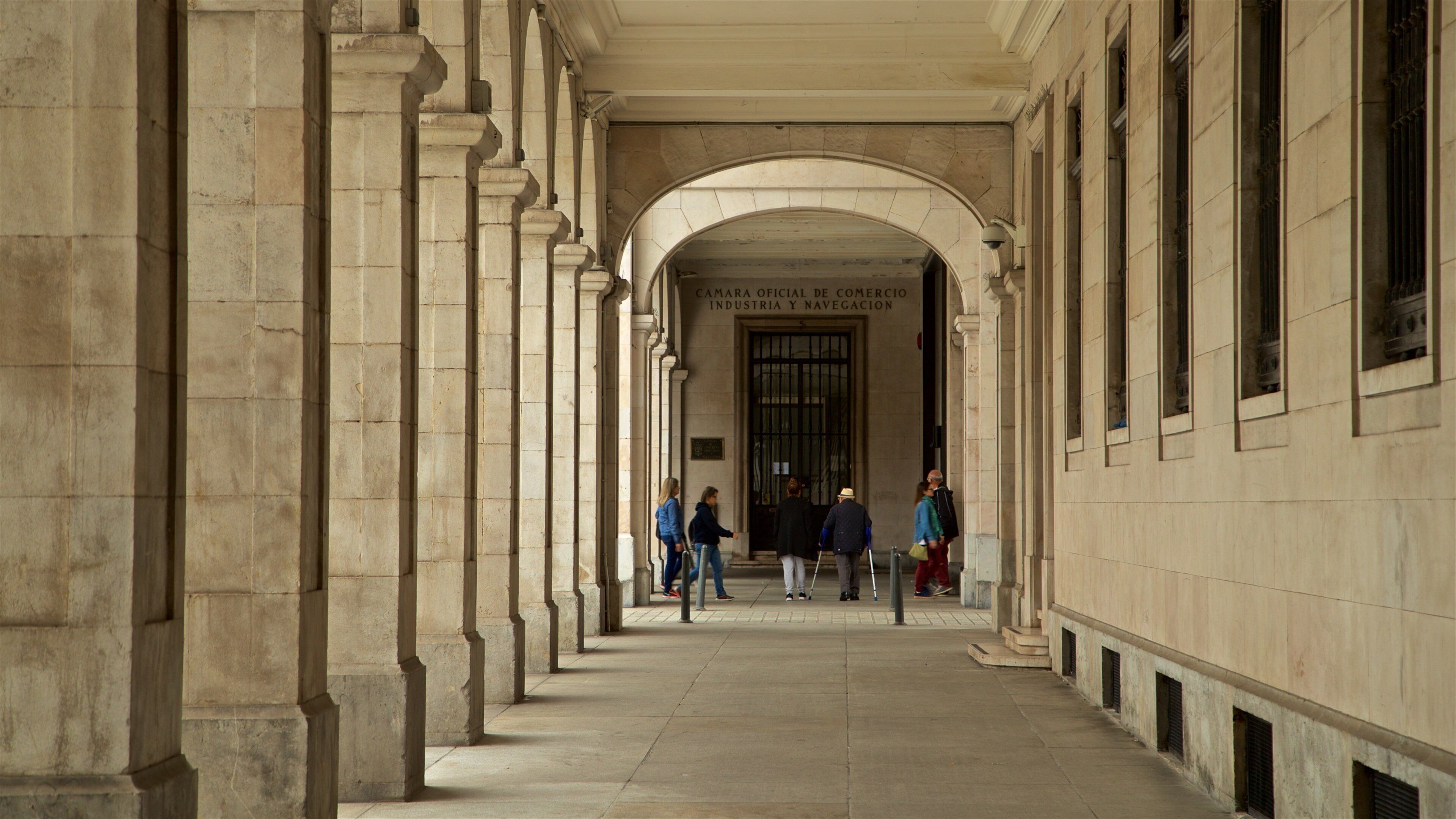 Plaza Porticada featuring interior views and heritage elements as well as a small group of people