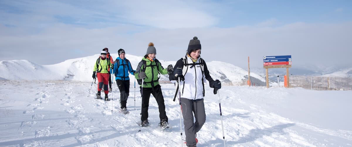La Molina Ski Resort showing snow and snow shoeing as well as a small group of people