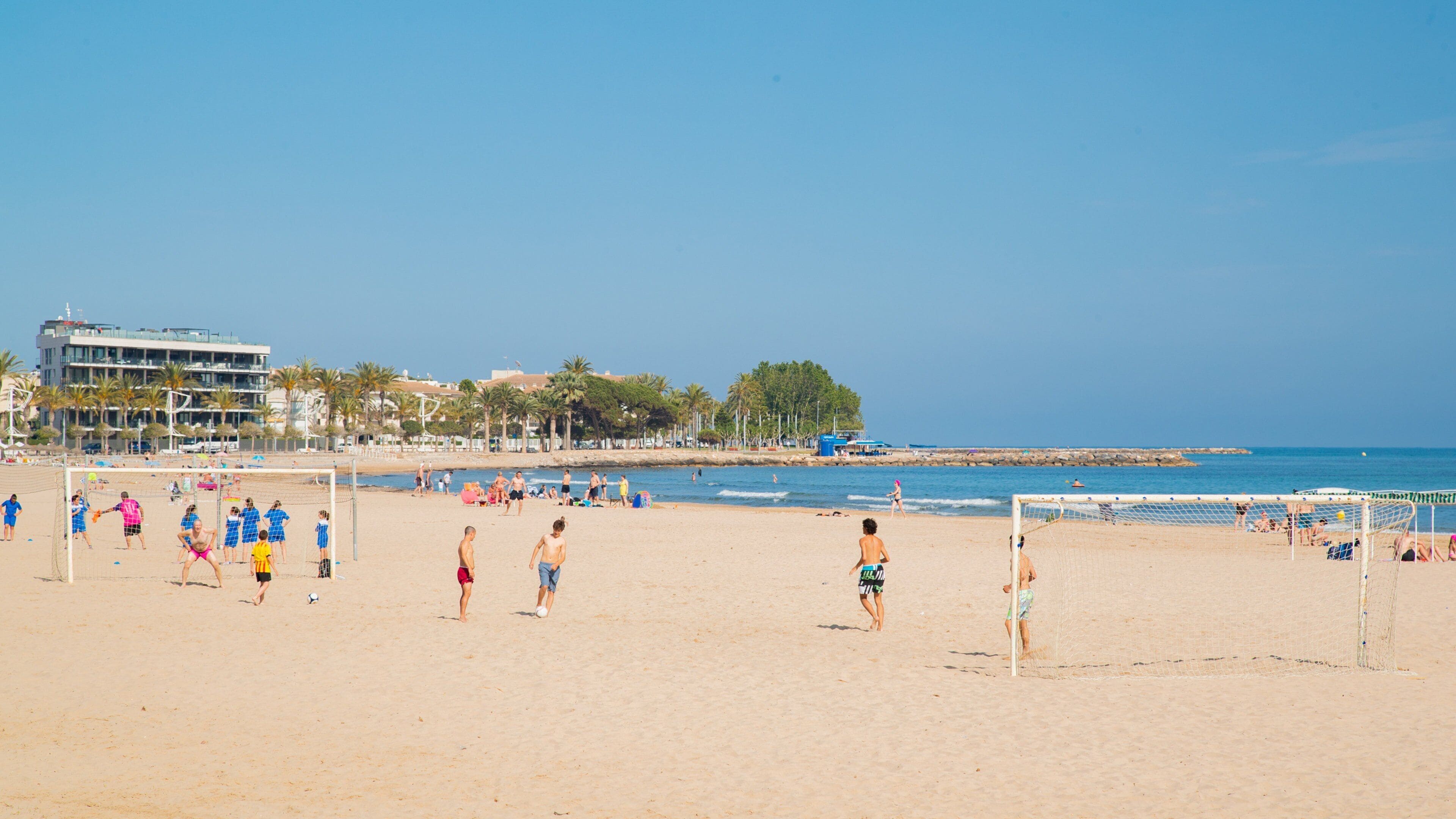 Cambrils Beach featuring a beach and general coastal views as well as a small group of people
