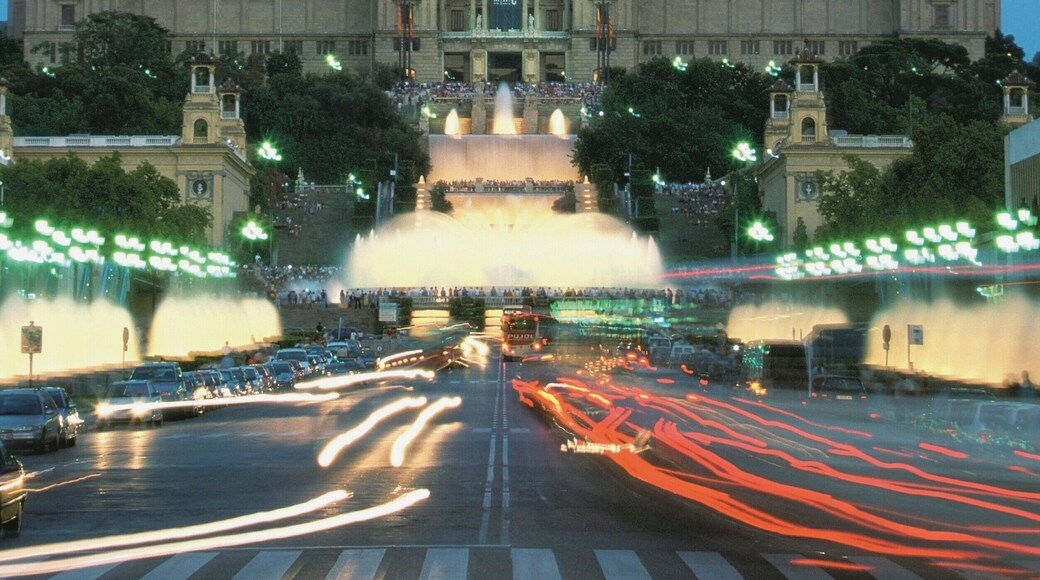 Facade of National Palace and Magic Fountain lit up at twilight, Plaza de Espanya, Barcelona, Spain