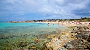 Es Pujols Beach which includes rocky coastline, general coastal views and swimming