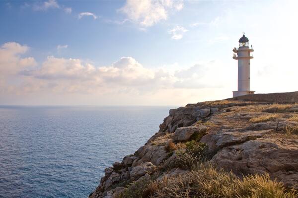 Cap de Barbaria Lighthouse featuring a sunset, general coastal views and a lighthouse
