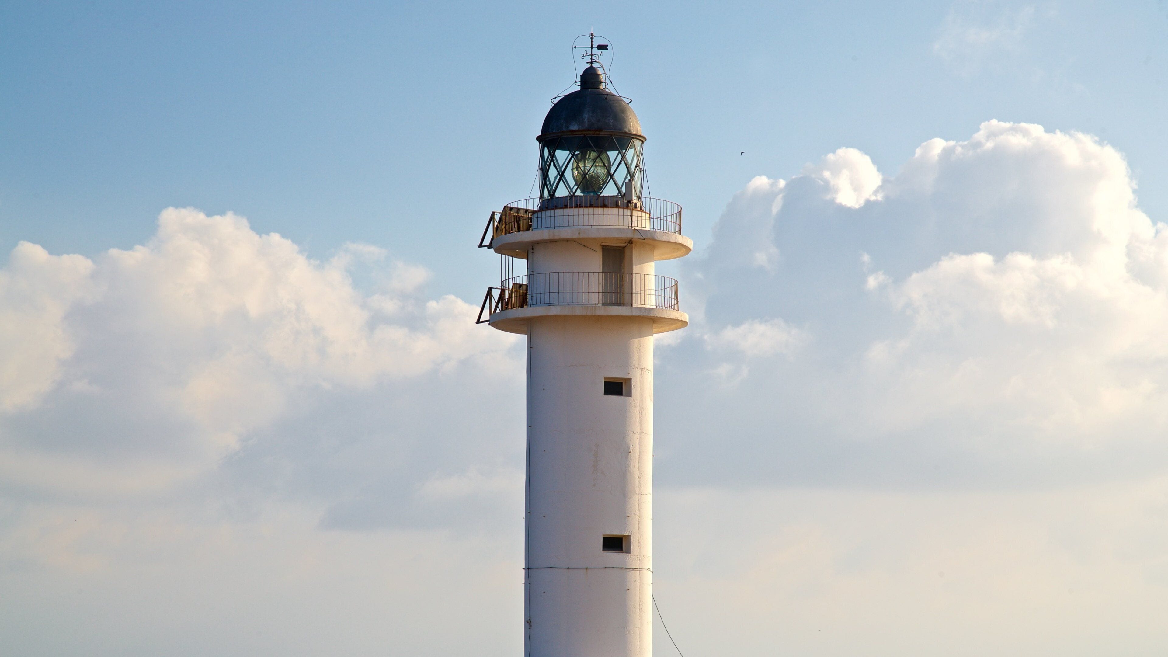 Cap de Barbaria Lighthouse featuring a lighthouse and a sunset