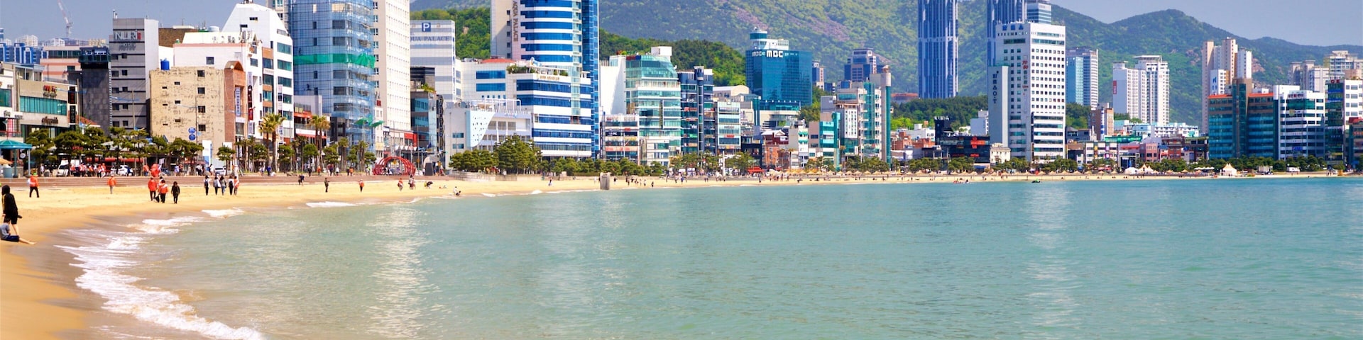 Gwangalli Beach showing a coastal town, a sandy beach and general coastal views