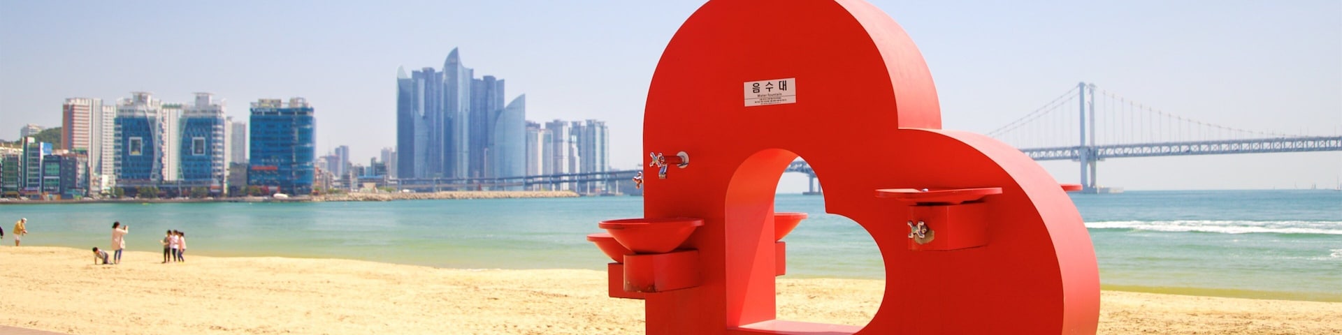 Gwangalli Beach featuring outdoor art, a bridge and general coastal views