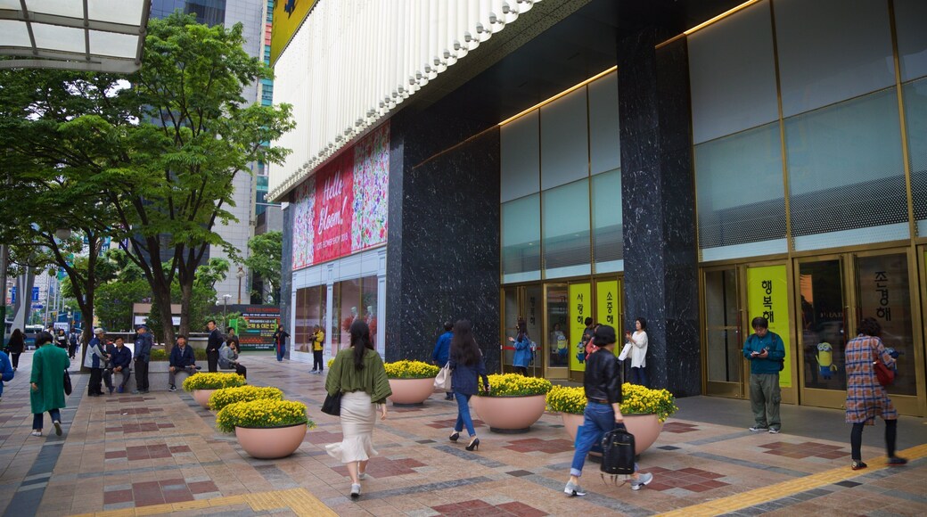 Lotte Department Store Busan Main Branch which includes street scenes and flowers as well as a small group of people