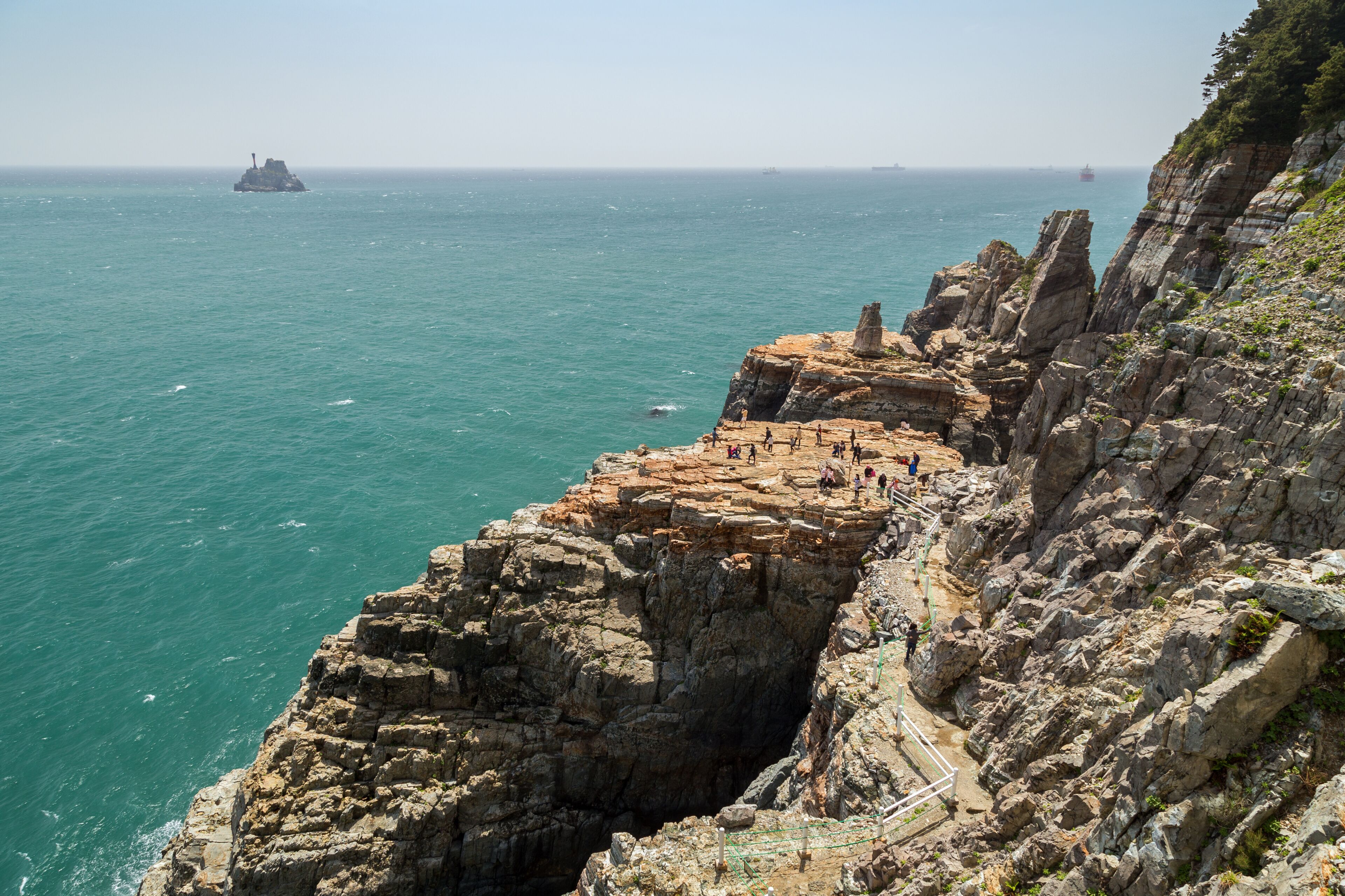 View of Sinseon Rock, rocky and steep cliff and ocean at the Taejongdae Resort Park in Busan, South Korea.