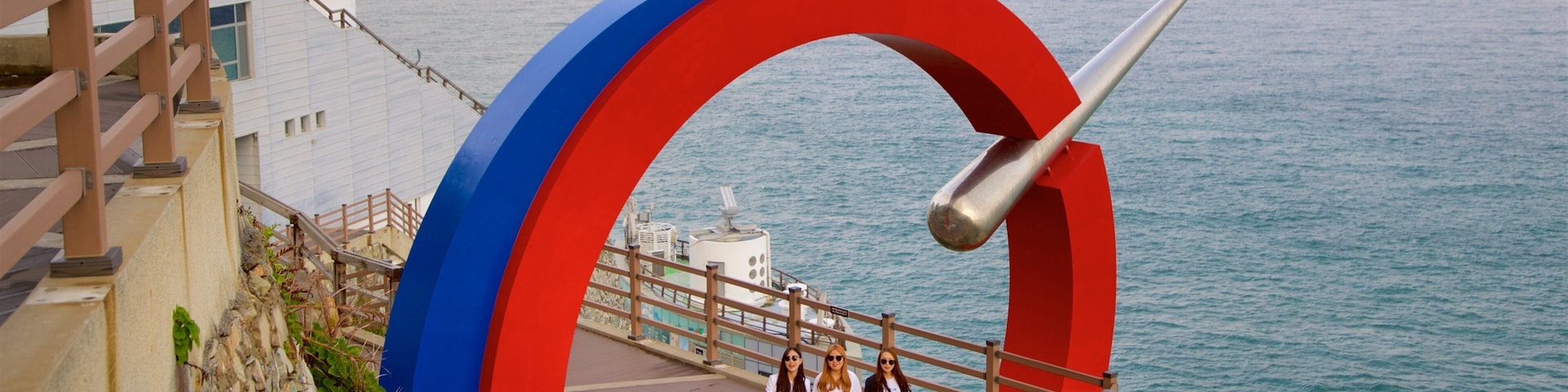 Taejongdae Park which includes general coastal views and views as well as a small group of people