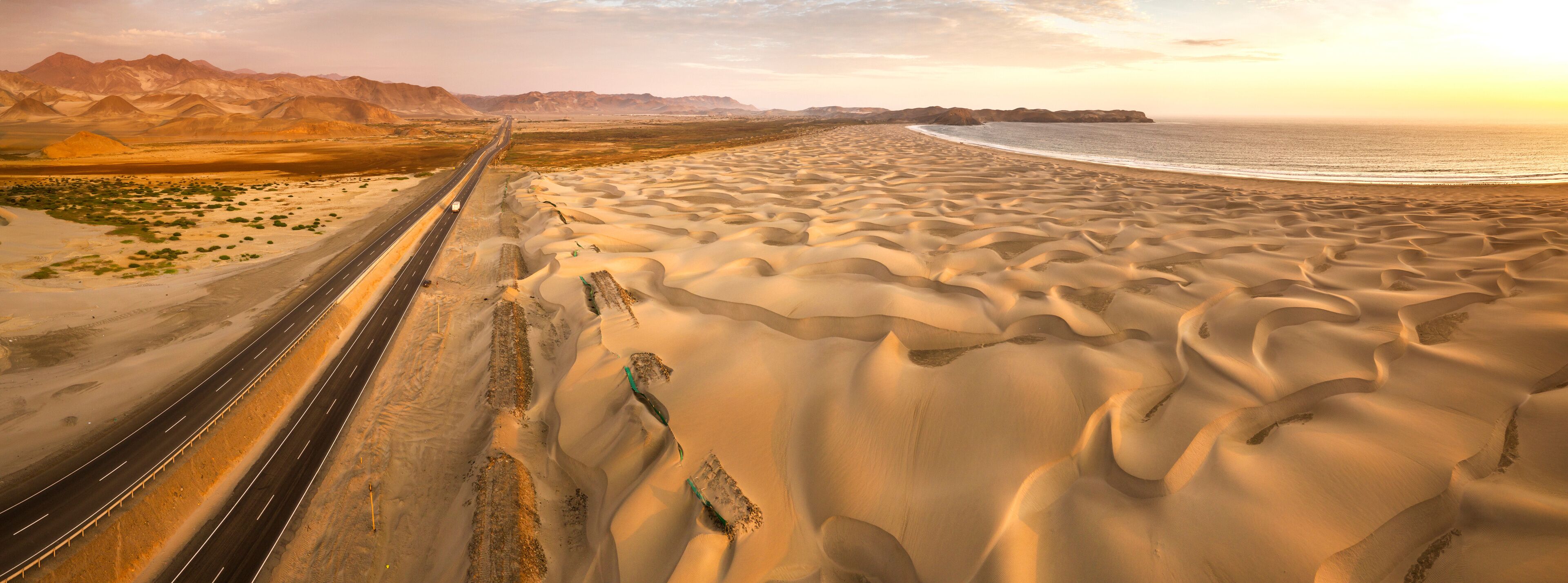 Aerial view of sand dunes in the Peruvian desert at side of the Panamericana international roadway in Ancash, Peru
