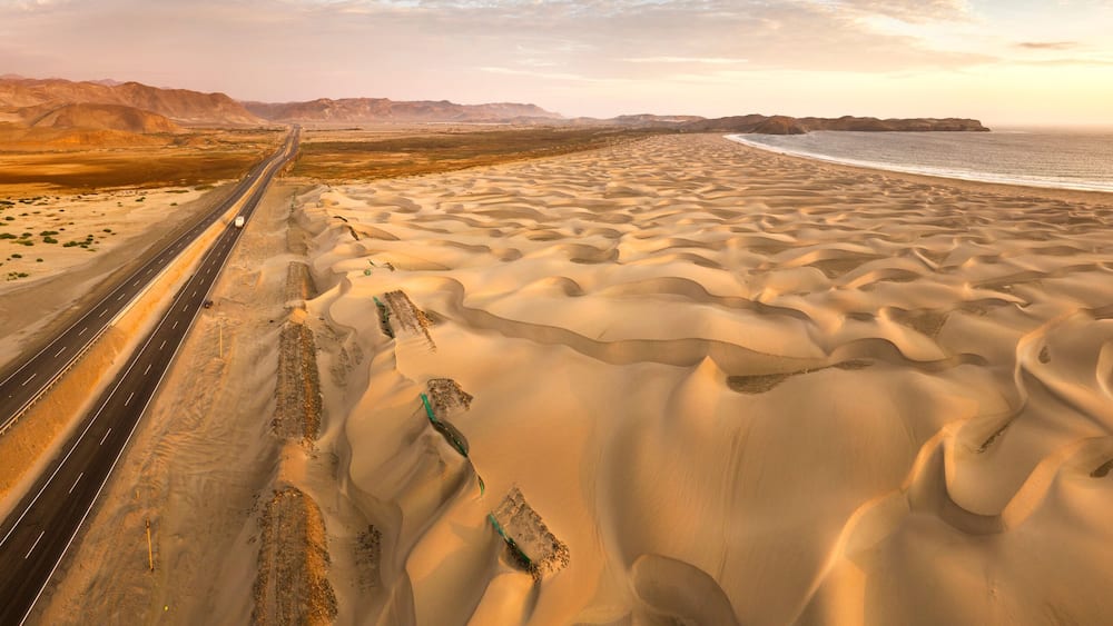 Aerial view of sand dunes in the Peruvian desert at side of the Panamericana international roadway in Ancash, Peru