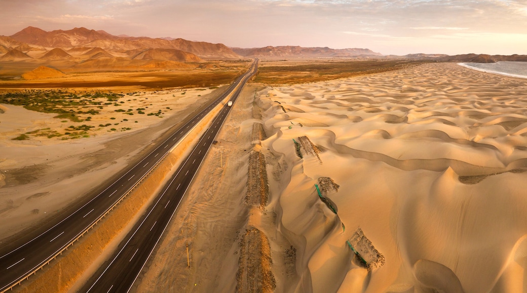 Aerial view of sand dunes in the Peruvian desert at side of the Panamericana international roadway in Ancash, Peru