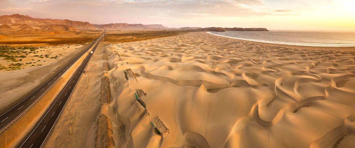 Aerial view of sand dunes in the Peruvian desert at side of the Panamericana international roadway in Ancash, Peru